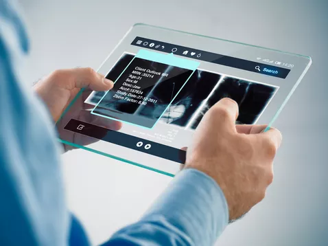 A picture of a person holding a futuristic tablet